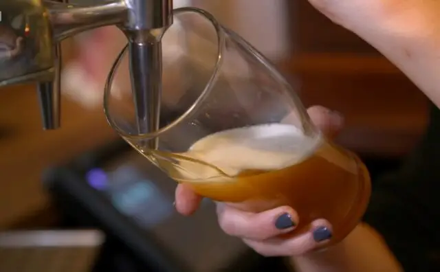 Pouring a beer in glass